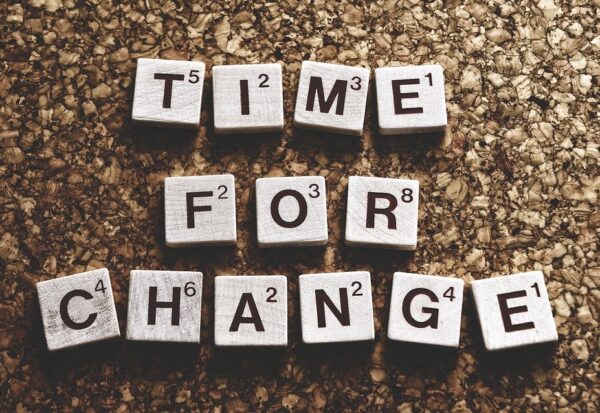 Time for change written in blocks against a surface